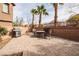 Spacious brick-paved patio with a grill and fire pit, ideal for outdoor cooking and gatherings at 1100 Paradise Coach Dr, Henderson, NV 89002