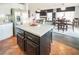 Modern kitchen with stainless steel appliances and center island, flowing into dining area at 1100 Paradise Coach Dr, Henderson, NV 89002