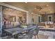 Covered outdoor dining area with a sleek table and chairs, seamlessly connected to the interior living space at 11110 Mount Cass St, Las Vegas, NV 89141