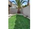Backyard with artificial grass and boulders adjacent to a landscaped xeriscape area and gazebo at 11118 Scotscraig Ct, Las Vegas, NV 89141