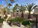 Lush backyard featuring mature palm trees, manicured gravel and artificial grass at 11118 Scotscraig Ct, Las Vegas, NV 89141