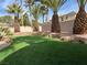 A yard with artificial grass and well-placed boulders, with manicured desert landscaping at 11118 Scotscraig Ct, Las Vegas, NV 89141