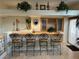A bar area with four ornate bar stools, a built-in sink, and storage cabinets for beverages at 11118 Scotscraig Ct, Las Vegas, NV 89141