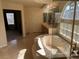 Bright bathroom featuring a soaking tub with glass block window, double sink vanity, and neutral tile flooring at 11118 Scotscraig Ct, Las Vegas, NV 89141