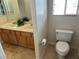 Bright bathroom featuring a toilet and double sinks with storage at 11118 Scotscraig Ct, Las Vegas, NV 89141