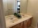 Bathroom featuring double sinks, wooden cabinets, and neutral countertops provides functionality and style at 11118 Scotscraig Ct, Las Vegas, NV 89141