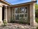 Side view of a home featuring a unique bay window, desert landscaping and rock ground covering at 11118 Scotscraig Ct, Las Vegas, NV 89141