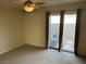 Bright bedroom with a ceiling fan and sliding glass doors leading to the backyard at 11118 Scotscraig Ct, Las Vegas, NV 89141