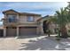 Two-story home with a three-car garage and desert landscaping at 11118 Scotscraig Ct, Las Vegas, NV 89141