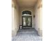 A covered front entrance with double doors, decorative lighting fixtures, and stone walkway at 11118 Scotscraig Ct, Las Vegas, NV 89141
