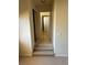 Hallway featuring carpet and tile flooring leading to a door providing seamless transitions at 11118 Scotscraig Ct, Las Vegas, NV 89141