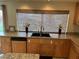 Kitchen featuring wood cabinets, granite countertops, modern appliances and stylish decor at 11118 Scotscraig Ct, Las Vegas, NV 89141