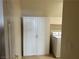 Laundry room with ample storage in a utility closet and a white washing machine at 11118 Scotscraig Ct, Las Vegas, NV 89141