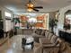 Spacious living room with tile flooring, a ceiling fan, and a view of the kitchen and dining area at 11118 Scotscraig Ct, Las Vegas, NV 89141
