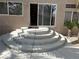 Back patio entrance featuring unique steps and manicured landscaping at 11118 Scotscraig Ct, Las Vegas, NV 89141