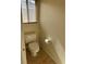 A cozy powder room offers tile flooring, a standard toilet, and a toilet paper holder at 11118 Scotscraig Ct, Las Vegas, NV 89141