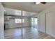 Open-concept living room with wood-look floors, natural light, and sliding door access to the pool at 1681 Parkchester Dr, Las Vegas, NV 89108