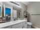 Bright bathroom with dual sinks, a large mirror, and modern fixtures at 1888 Apricot Ct, Henderson, NV 89014