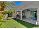 Expansive backyard with lush artificial turf, a covered patio, built-in grill, and a serene ambiance for outdoor enjoyment at 2010 Spruce Brook Dr, Henderson, NV 89074