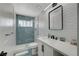 Updated bathroom with a modern vanity, a walk-in shower with geometric tiling, and a framed mirror at 2010 Spruce Brook Dr, Henderson, NV 89074