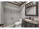 Cozy powder room with a dark vanity, gray walls, and decorative mirror at 2010 Spruce Brook Dr, Henderson, NV 89074