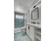 Renovated bathroom featuring a walk-in shower with geometric tiling, modern vanity, and a framed mirror at 2010 Spruce Brook Dr, Henderson, NV 89074