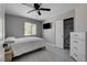 This bedroom offers a ceiling fan, TV and a large window with a view of the landscaping at 2010 Spruce Brook Dr, Henderson, NV 89074