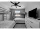 Neutral tone bedroom with two bunk beds, a ceiling fan, and a dresser with a TV at 2010 Spruce Brook Dr, Henderson, NV 89074