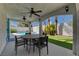 Enjoy outdoor dining on the covered patio with ceiling fans and views of the refreshing pool and lush backyard at 2010 Spruce Brook Dr, Henderson, NV 89074