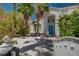 Inviting front entrance with a bright blue door and lush landscaping at 2010 Spruce Brook Dr, Henderson, NV 89074