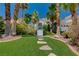 Beautiful home exterior with manicured lawn, mature trees, and inviting walkway at 2010 Spruce Brook Dr, Henderson, NV 89074