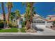 Charming two-story home with a well-manicured lawn and mature trees at 2010 Spruce Brook Dr, Henderson, NV 89074