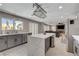 Open-concept kitchen boasts stainless steel appliances, an island, and two-tone cabinetry at 2010 Spruce Brook Dr, Henderson, NV 89074