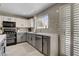 Modern kitchen featuring stainless steel appliances, two-tone cabinets, and bright, natural light at 2010 Spruce Brook Dr, Henderson, NV 89074