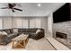 Bright living room with a large sectional sofa, fireplace, and natural light from shuttered windows at 2010 Spruce Brook Dr, Henderson, NV 89074