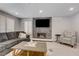 Cozy living room with a stone fireplace, modern furniture, and plenty of natural light at 2010 Spruce Brook Dr, Henderson, NV 89074