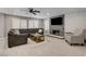 Comfortable living room with a sectional sofa, fireplace, and natural light from shuttered windows at 2010 Spruce Brook Dr, Henderson, NV 89074