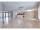 Open-concept living room with tile floors, modern ceiling fan, and open access to the kitchen at 2215 Bensley St, Henderson, NV 89044