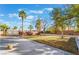 Spacious backyard with a grassy area, mature trees, block wall, and an extended concrete patio at 2241 Verde Cape Ave, Henderson, NV 89052