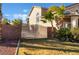 View of a well manicured backyard with a large iron gate and palm trees on a sunny day at 2241 Verde Cape Ave, Henderson, NV 89052