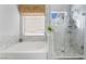 Luxurious bathroom featuring a soaking tub and a glass-enclosed shower with stylish tile work at 2241 Verde Cape Ave, Henderson, NV 89052