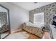Bedroom with decorative wall paper, wood laminate flooring, and full length mirror at 2241 Verde Cape Ave, Henderson, NV 89052