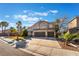 Inviting two-story home with a three-car garage and manicured front lawn at 2241 Verde Cape Ave, Henderson, NV 89052