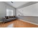 Bright living space featuring wood floors, a comfortable sofa, and natural light from a window at 2241 Verde Cape Ave, Henderson, NV 89052