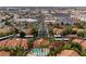 An aerial view showcases the community pool, lush landscaping, nearby shopping centers, and overall neighborhood layout at 2300 E Silverado Ranch Blvd # 2040, Las Vegas, NV 89183