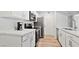 A bright kitchen features white cabinets, stainless steel appliances, and sleek quartz countertops at 2300 E Silverado Ranch Blvd # 2040, Las Vegas, NV 89183