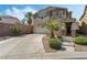 Inviting two-story home showcasing stone accents, well-manicured landscaping, and a private driveway at 2765 Rochester Run Ave, Henderson, NV 89052