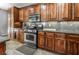 A modern kitchen features stainless steel appliances, granite countertops, and custom wood cabinetry at 2765 Rochester Run Ave, Henderson, NV 89052