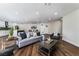 Bright open-concept living area with wood floors and modern furniture, open to the kitchen at 2909 Gilmary Ave, Las Vegas, NV 89102