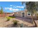 A backyard with desert landscaping, turf, and brick patio under a bright sky at 2910 Ventana Ridge Ave, Henderson, NV 89044